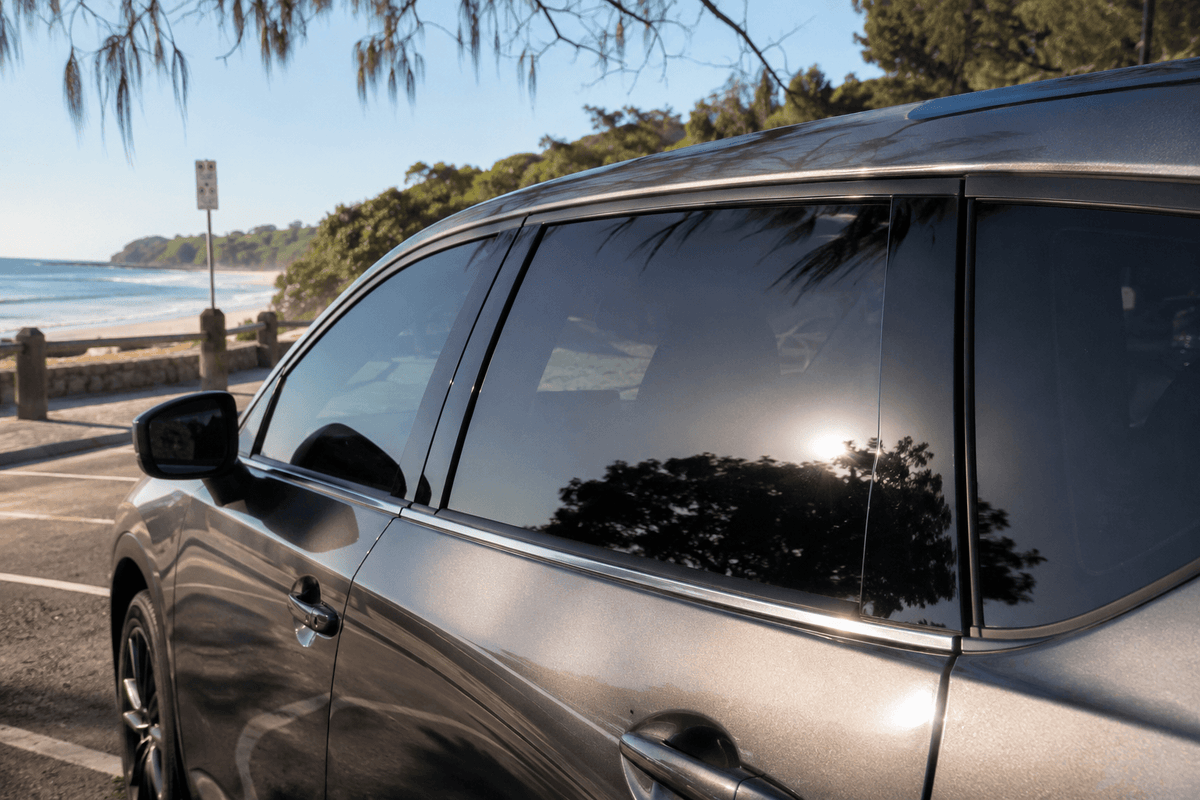 Car with ceramic window tint parked beside the beach in Noosa Heads