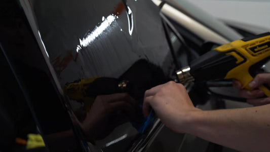 Car window tint preparation on window with the use of a heat gun