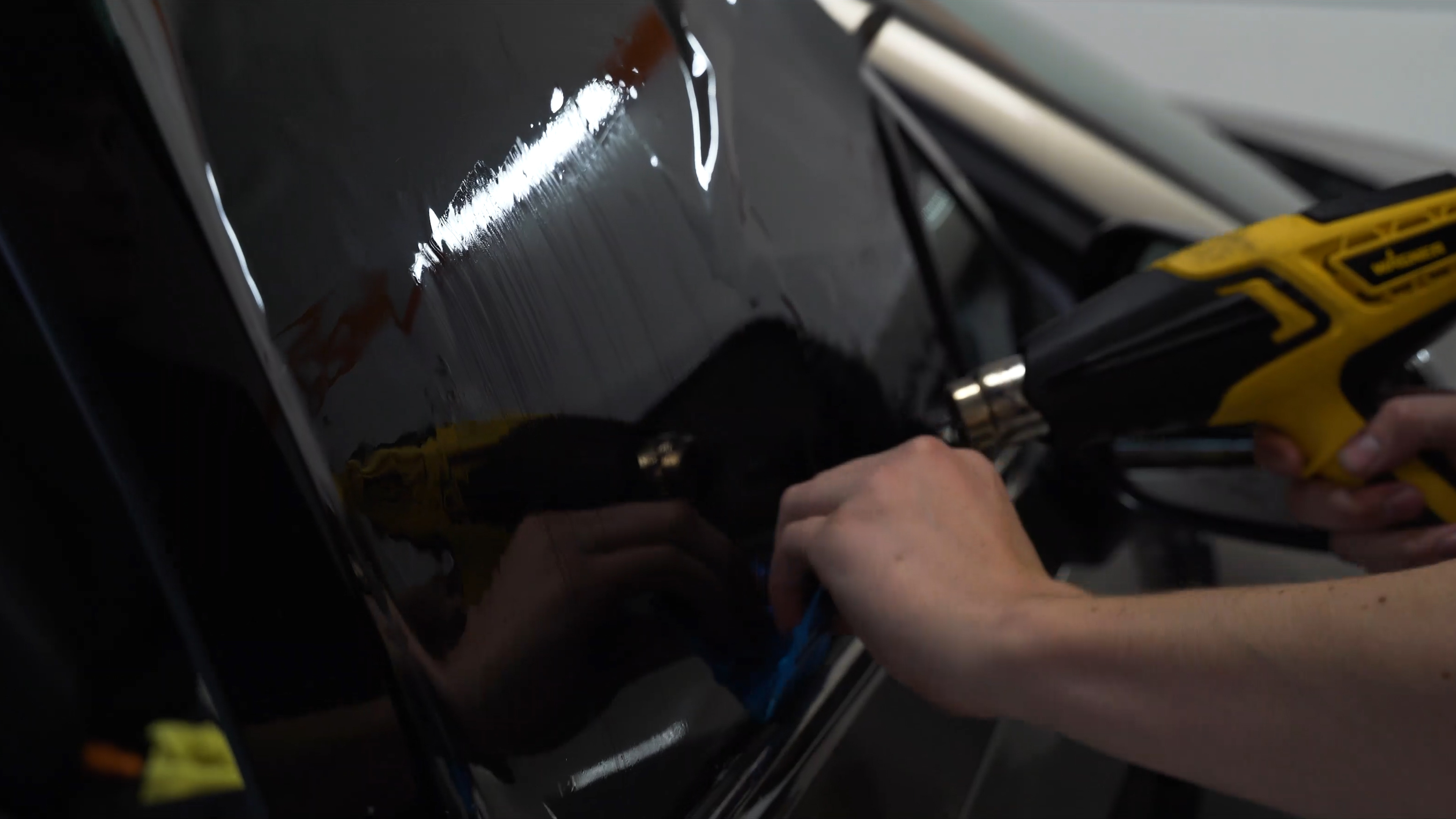 picture of a car detailing technician performing a paint correction